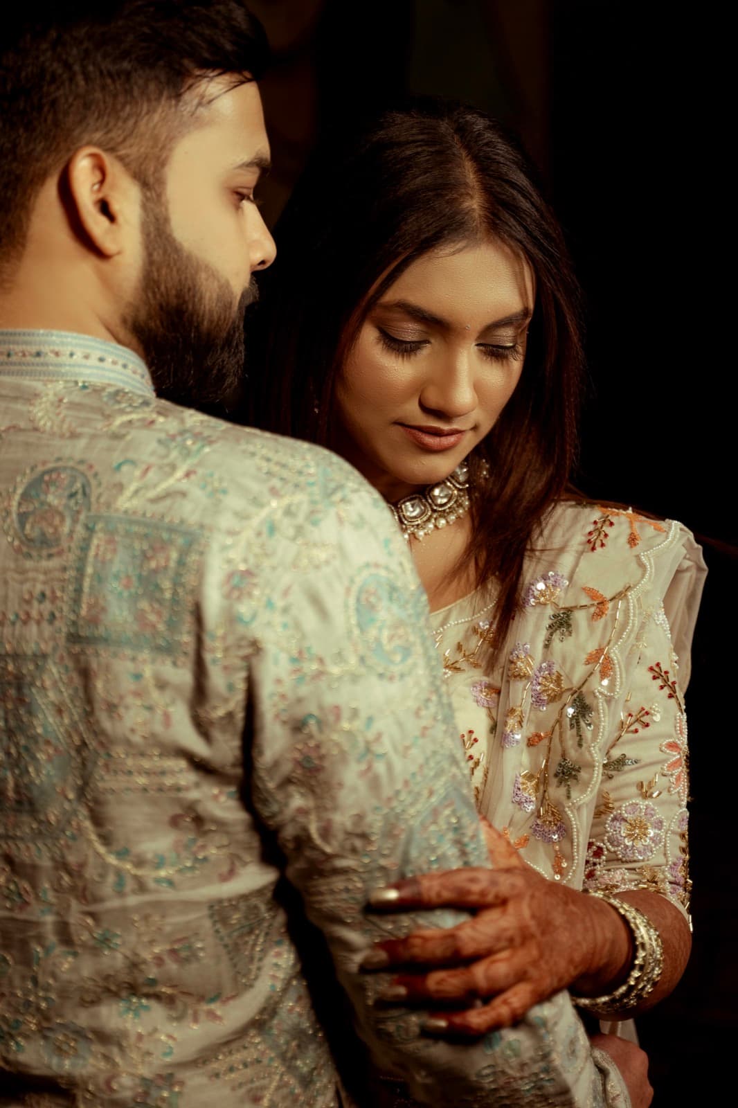 A couple in an affectionate embrace, foreheads close together