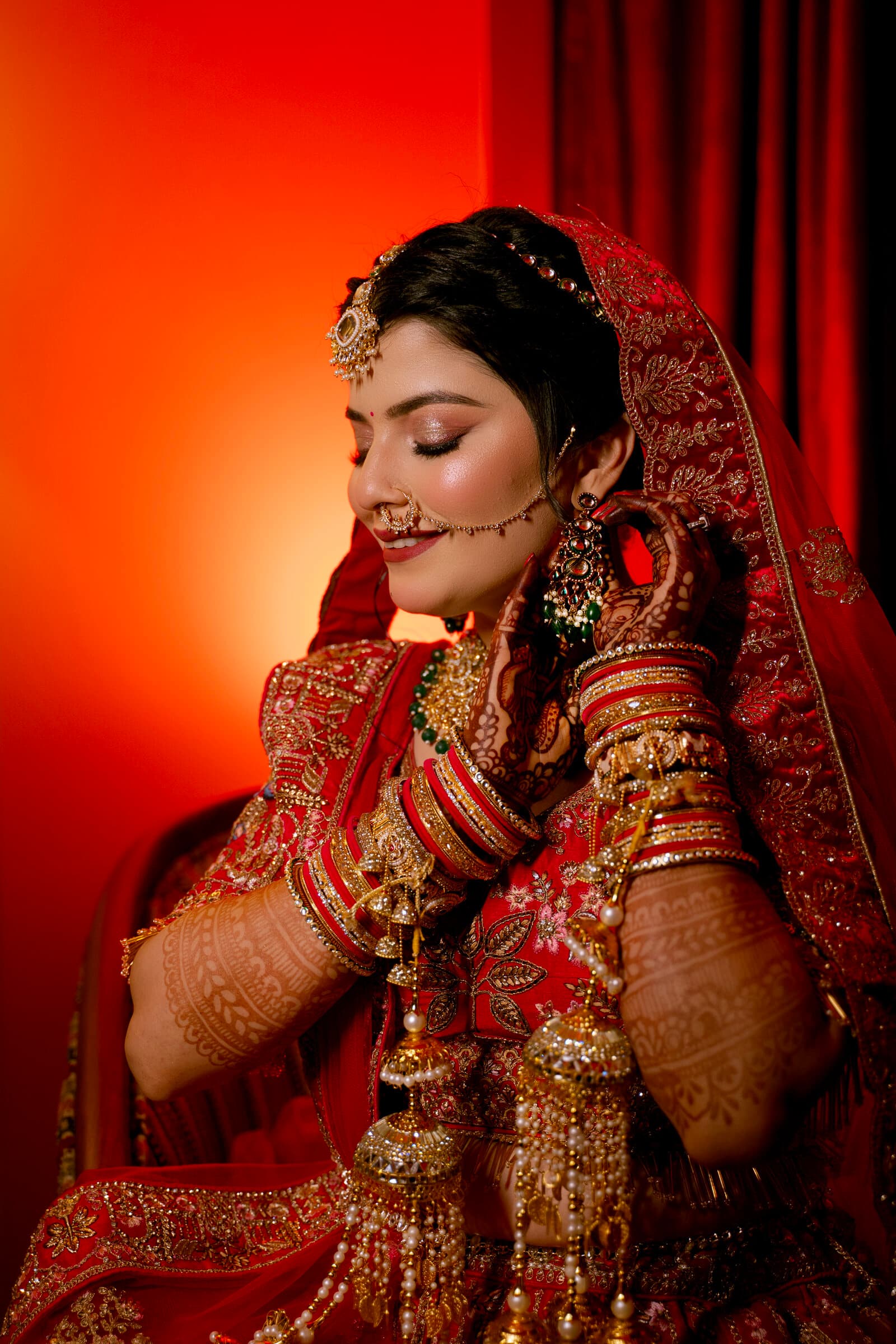 Bride draped in a red veil, dramatic close portrait